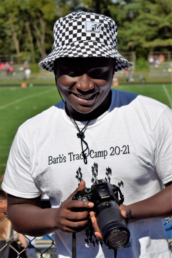 Odeyi Kizungu takes photos at Memorial Field.