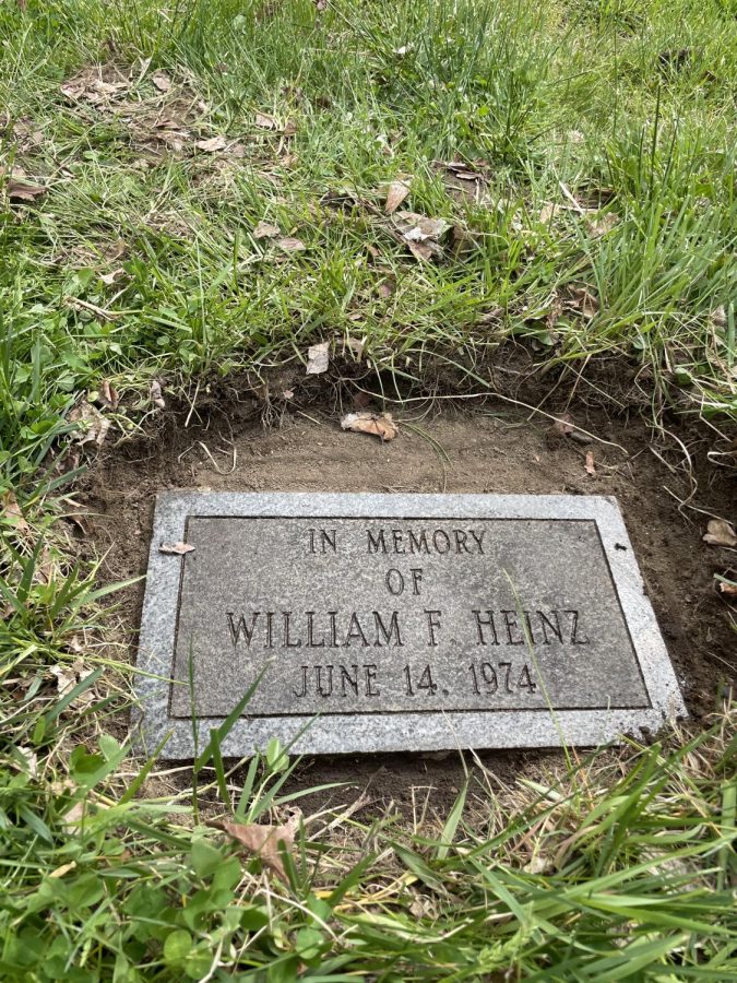 This tribute to former science teacher William F. Heinz was covered in grass and hard to find. Daisy LaPlante and Sophia Regan dug away the grass with their bare hands during a recent Journalism class foray.