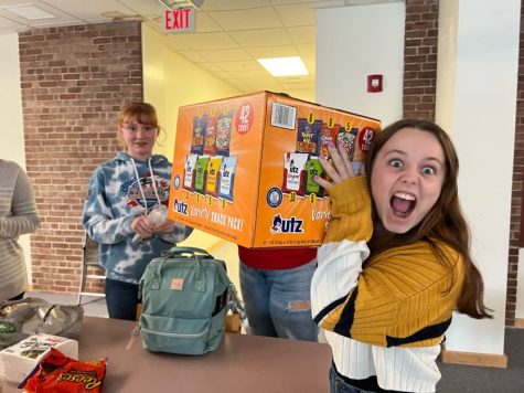 Victoria Lewis and Grace Parisi are excited about the snacks theyre about to serve at the Writing Clubs first annual horror story event Oct. 24, 2022.