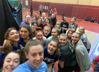 Players gather after a winter workout before softball tryouts last year. 