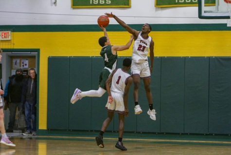 Alain Twite blocks a shot against Hopkinton in the Cap Area Holiday tournament championship game at Bishop Brady High School. Concord went on to win the Tournament Championship.