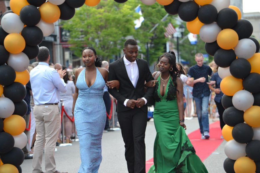 Yvette Uwase, Jimmy Rutikanga and Justine Uwamahoro walk the red carpet before the prom at Bank of New Hampshire Stage on South Main Street Thursday, June 15, 2023.
